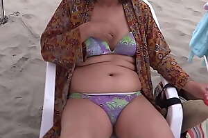 My latin wife well done 58-year-old matriarch enjoys the seashore shows off shows her hairy pussy of hers in a bikini she masturbates intense climaxes cumshot on her delicious body